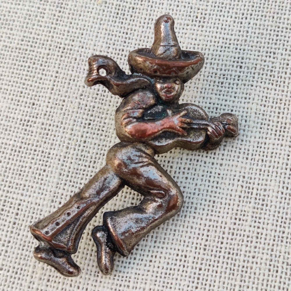 Antique Mexican man playing instrument brooch